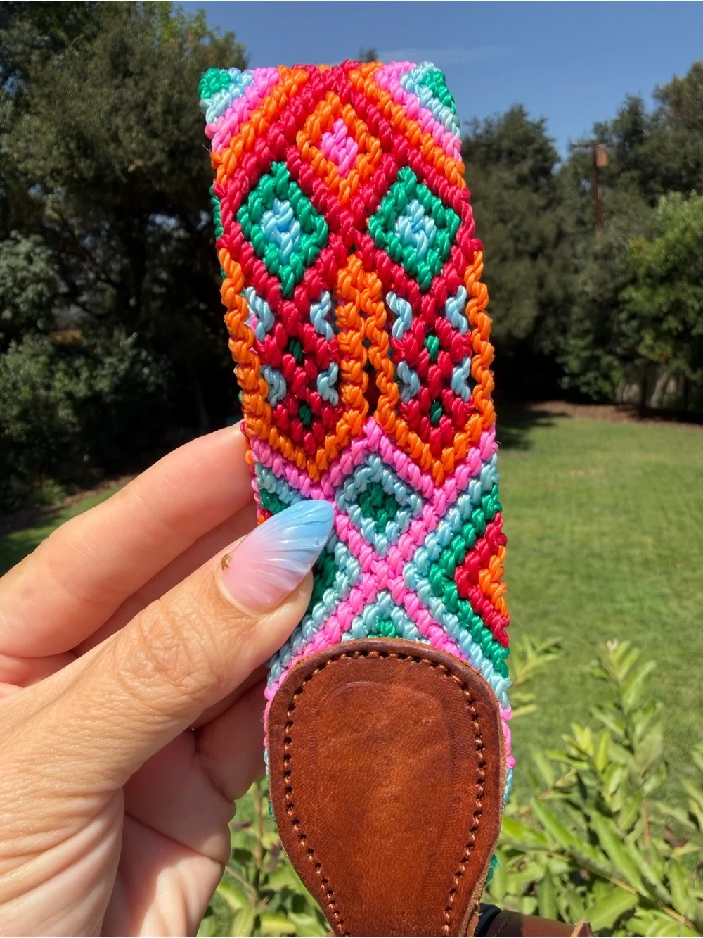 Hand-Tooled Round Leather Wristlet Bag with Colorful Woven Strap